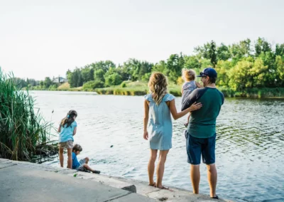 Young Family enjoying time by the river in Camrose